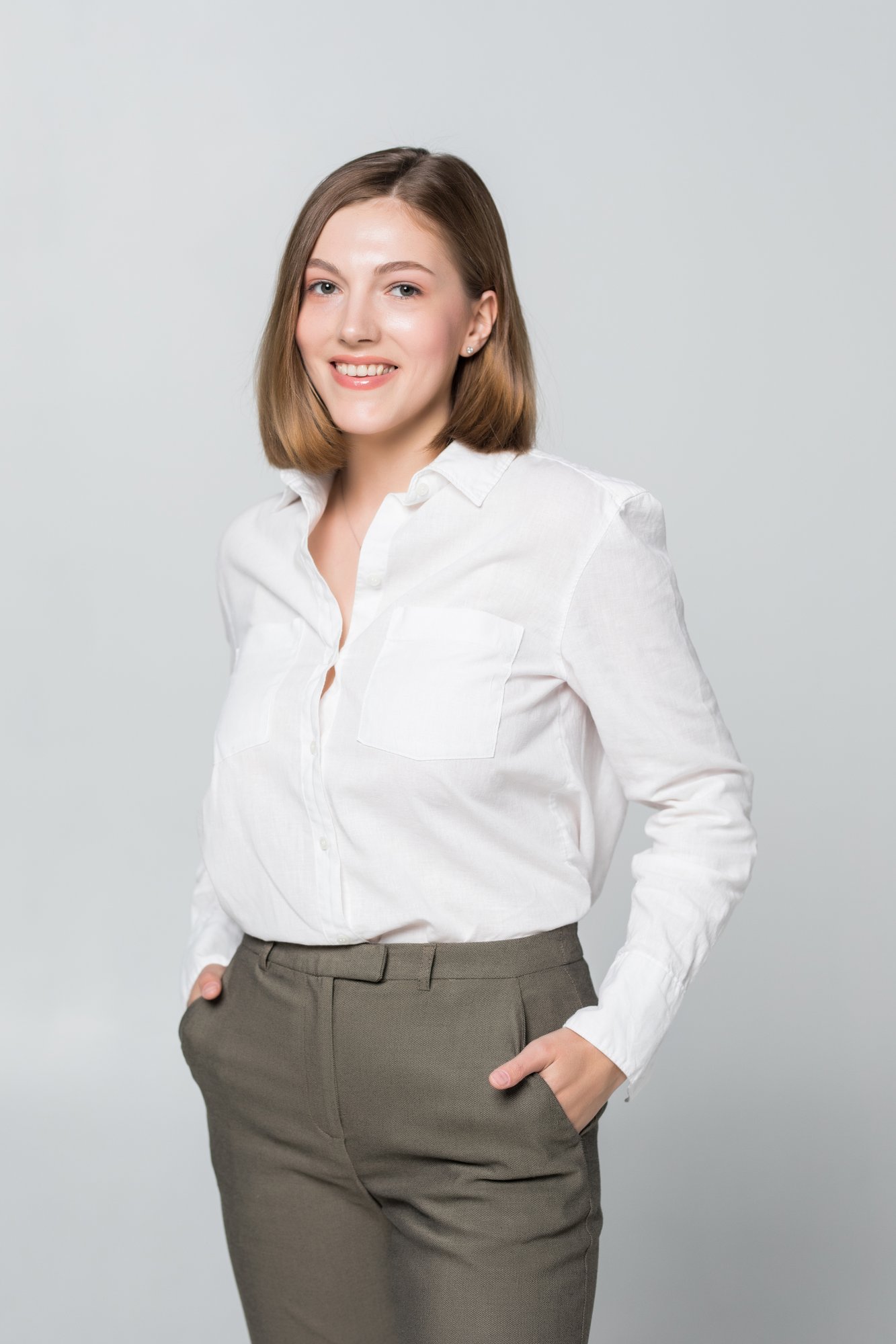 smiling-business-woman-with-folded-hands-toothy-smile-crossed-arms