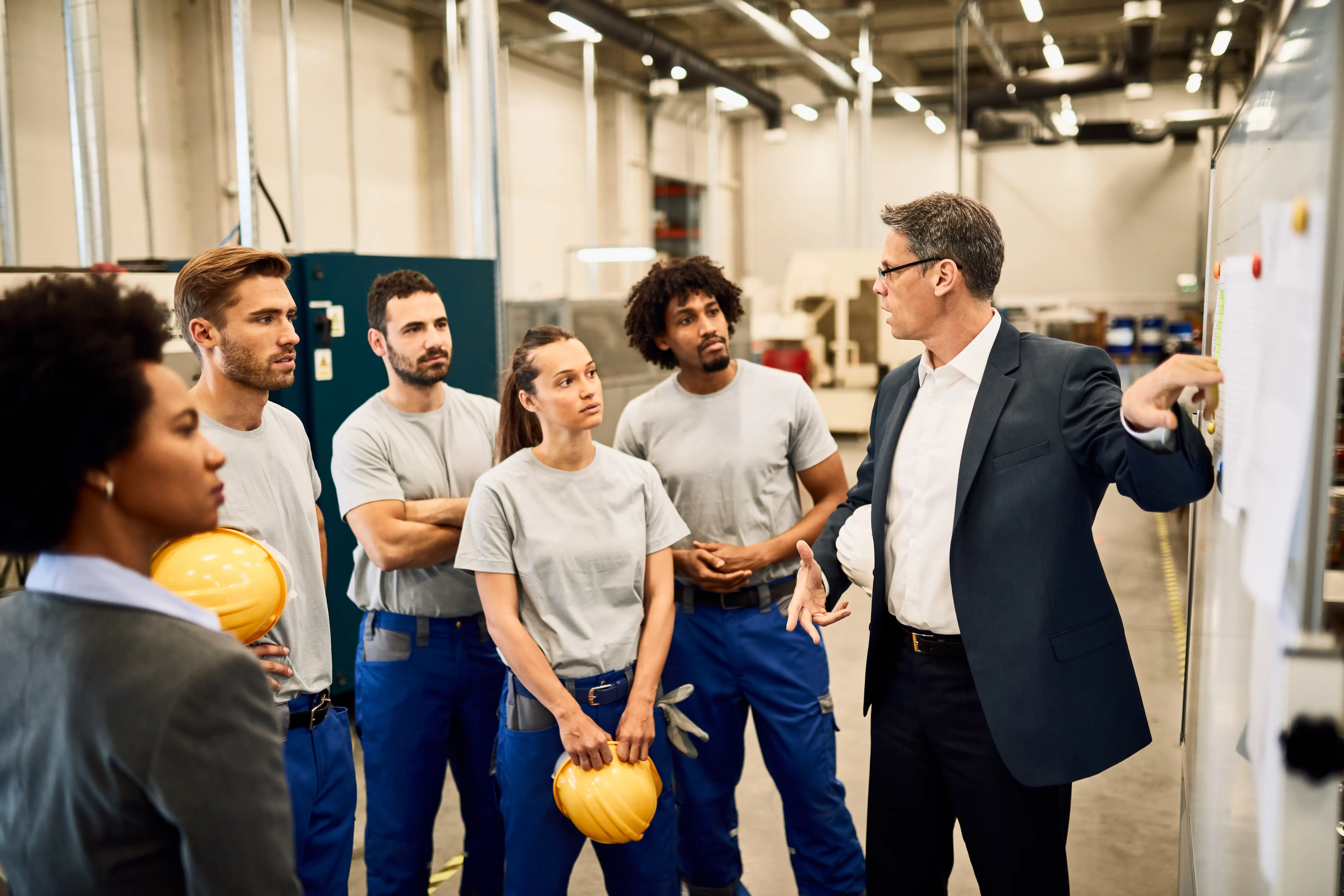 mid-adult-businessman-giving-presentation-group-industrial-workers-factory