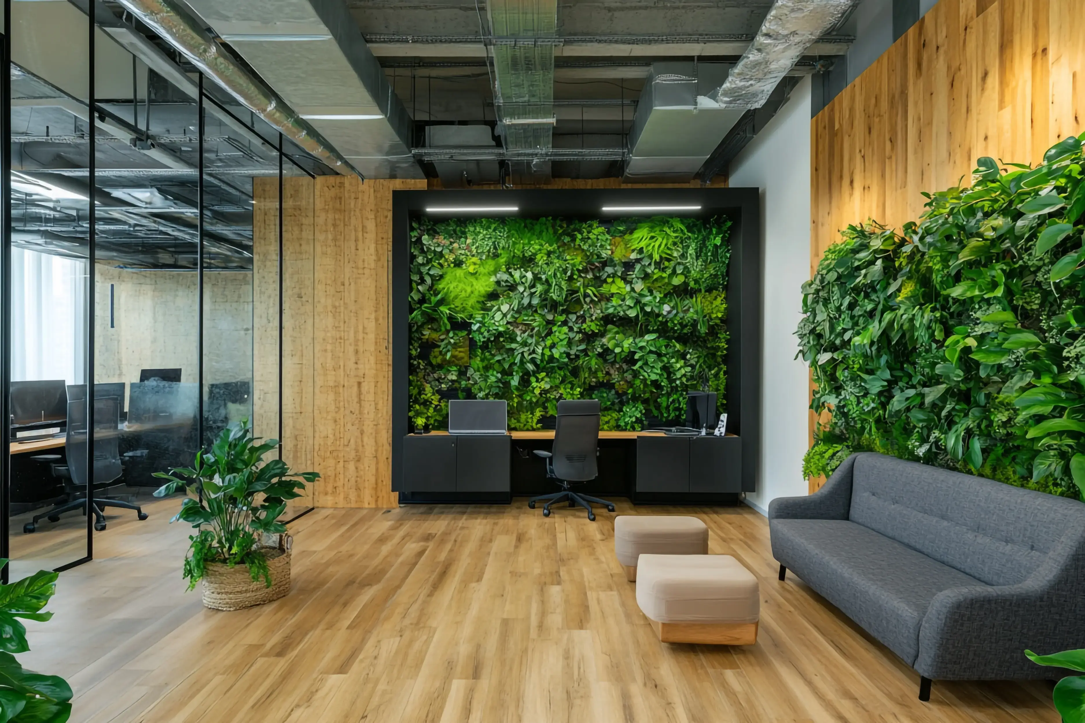 modern-office-with-green-wall-plants-wooden-floors-comfortable-seating (1)